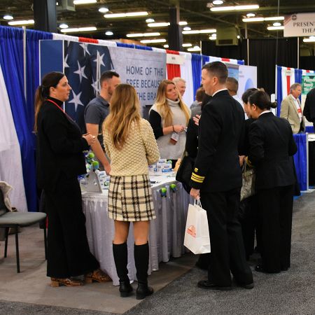 Attendees talking with exhibitors